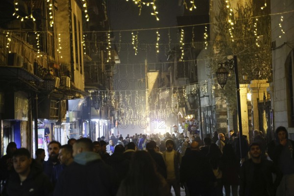 In Damascus, Syria, on December 25, 2025, festive scenes filled the streets and churches of the Bab Touma district, where thousands of people gathered to celebrate Christmas Eve amid holiday decorations and lights, Damascus, Damascus, Syria