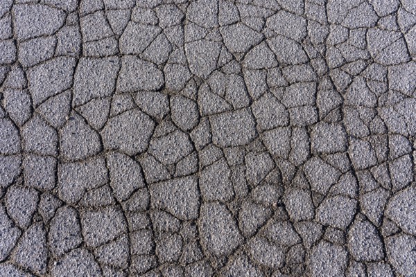 Asphalt surface, floor, with many small cracks, roadway, parking lot