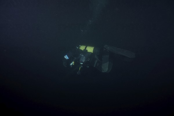 Divers at night in Lake Walen. Tauchplatz Känzeli, Mols, Canton of St. Gallen, Switzerland