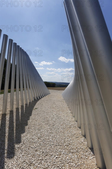 Art in public space, sculpture made of aluminum profile pipes by artist Martin Burchard, life's horizon path near Mundingen, light and shadow, gravel, clouds, blue sky, walk-in art, paths of reflection and refreshment on the Ehinger Alb, Baden-Württemberg, Germany