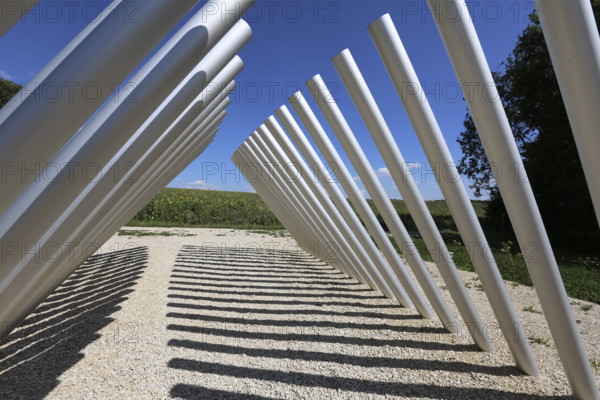 Art in public space, sculpture made of aluminum profile pipes by artist Martin Burchard, life's horizon path near Mundingen, light and shadow, gravel, clouds, blue sky, walk-in art, paths of reflection and refreshment on the Ehinger Alb, Baden-Württemberg, Germany