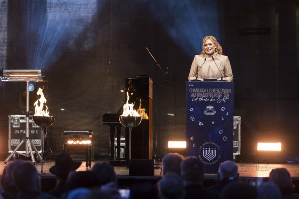 Julia Klöckner (President of the German Bundestag) speaks at the lighting of lights to mark 20 years of Hanukkah in front of the Brandenburg Tor, Berlin, 17 December 2025