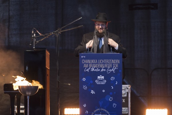 Yehuda Teichtal (Rabbi of the Chabad-Lubavitch movement) speaks at the lighting of lights to mark 20 years of Hanukkah in front of the Brandenburg Tor tor, Berlin, 17 December 2025
