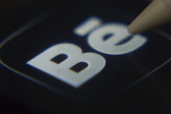 Dhaka, Bangladesh- 06 Dec 2025: Close-up of the Behance app on a screen with a stylus pointing at it