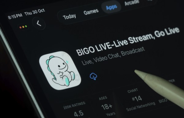 Dhaka, Bangladesh- 30 Oct 2025: Bigo Live app displayed on a iPad screen in dark mode with a digital pen pointing at it