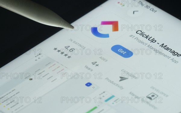 Dhaka, Bangladesh- 30 Oct 2025: ClickUp app on a iPad screen with a pen pointing at the install option