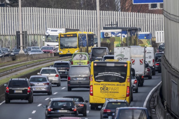 Heavy traffic on the A40 motorway, Ruhrschnellweg, height of the Essen-Ost motorway junction, looking east, 6-lane motorway, with 2 bus lanes in the middle, rush hour traffic, North Rhine-Westphalia, Germany