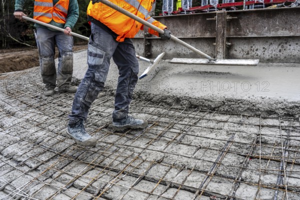 Concreting, concreting the foundation of a wind turbine, more than 600 cubic meters of concrete will be pumped into the foundation for over 7 hours, over 100 tons of reinforcing steel have been used, the wind turbine will have a hub height of 160 meters, part of a new wind farm in Sauerland, near Balve, North Rhine-Westphalia, Germany