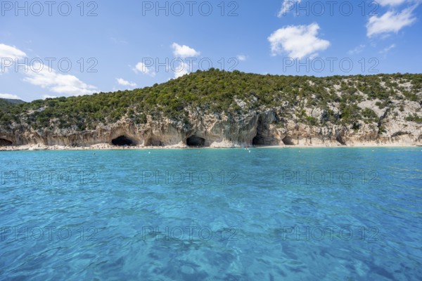 Clear blue water and picturesque rocky coast, Cala Luna cliffs and beach, Golfo di Orosei, Baunei, Sardinia, Italy