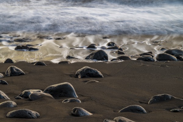 Sunset, waves and rocks in the sea, Praia Formosa, Madeira, Portugal