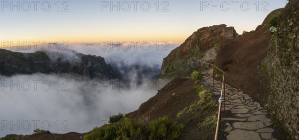 Sunrise at Pico do Arieiro, clouds of fog sweep over mountain peaks, sea of fog, hiking trail PR1, Madeira, Portugal