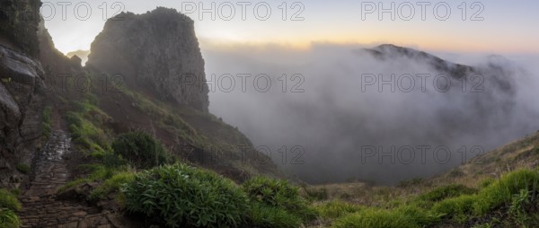 Sunrise at Pico do Arieiro, clouds of fog pass over mountain peaks, hiking trail PR1, Madeira, Portugal
