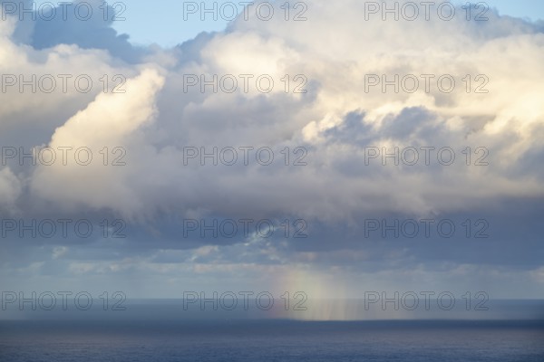 Rainbow over sea, dark rain cloud, rain, Madeira, Portugal