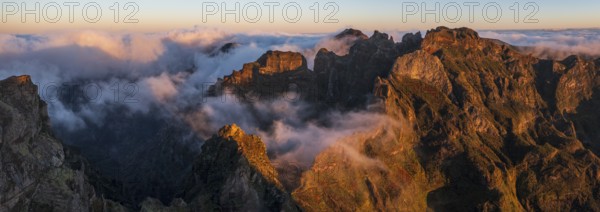 Aerial view, sunrise at Pico do Arieiro, clouds of fog sweeping over mountain peaks, Madeira, Portugal