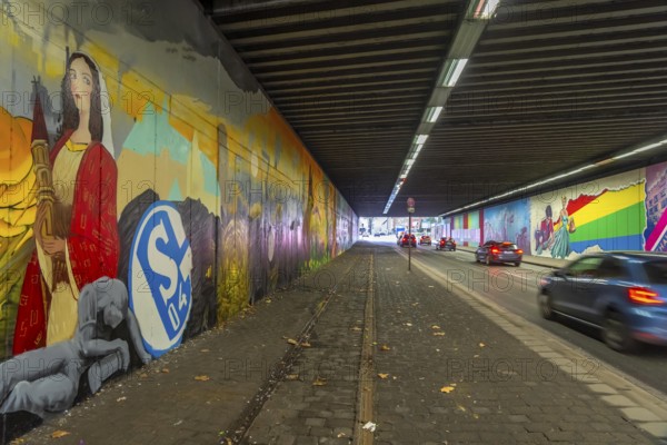 Huge street art pictures in a road tunnel in Gelsenkirchen, the approximately 120 meter long railway underpass of Wickingstraße was extensively painted and sprayed on both sides by 11 Gelsenkirchen graffiti artists and collectives, over a total length of 174 meters, the wall paintings showed motifs from Gelsenkirchen history, from economy, coal, steel, soccer, Schalke 04, culture, life, to the 150.year-old city Anniversary on 29.11.25, North Rhine-Westphalia, Germany