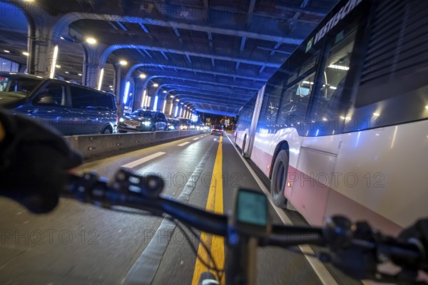Cycling in the city, in the dark, in the evening, cycling underpass at the main train station, in downtown Essen, North Rhine-Westphalia, Germany