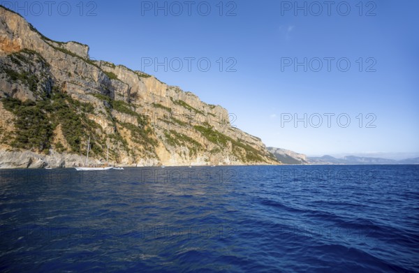 Picturesque rocky coast, cliffs in morning light, blue sea, Golfo di Orosei, Baunei, Sardinia, Italy