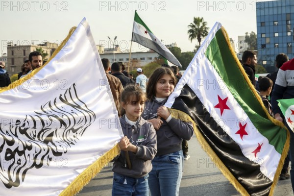 Damascus, Syria. November 28, 2025: Thousands of Syrians gather in Umayyad Square in central Damascus to celebrate the anniversary of the military operation that led to the fall of Bashar al-Assad's regime. Demonstrators express joy and unity while denouncing Israeli attacks on Syrian territory, Damascus, Damascus, Syria