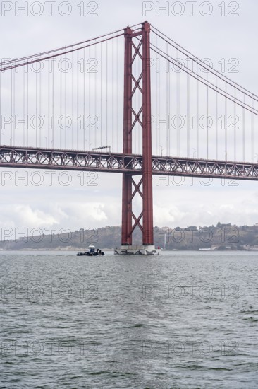 The Ponte 25 de Abril, 3.2 km long bridge in Portugal with a 2278 meter long suspension bridge across the Tagus, cloudy and rainy weather, third-longest suspension bridge with combined road and rail traffic, Lisbon, Portugal
