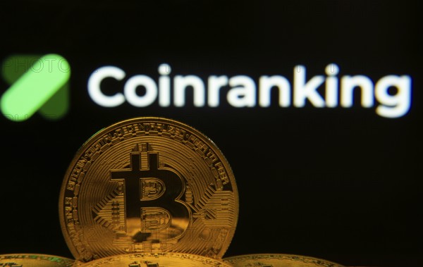 Dhaka, Bangladesh- 19 Sep 2025: Close-up of Bitcoin coins with the Coinranking logo visible on a screen in the background
