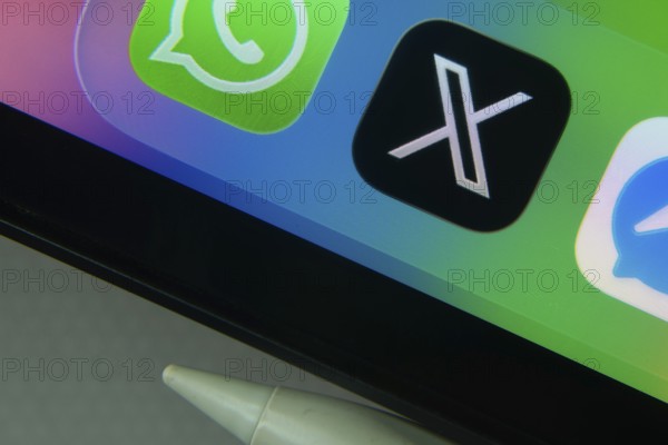 16 Nov 2025- Dhaka, Bangladesh: X and other app icons with a digital pen on a iPad screen