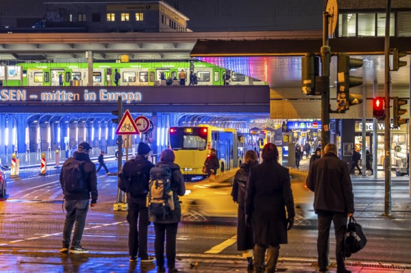 The main train station in Essen, blue illuminated underpass, bus station, am Europaplatz, train on the platform, pedestrian crossing, North Rhine-Westphalia, Germany