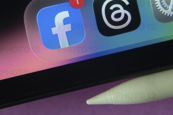 16 Nov 2025- Dhaka, Bangladesh: Facebook and other app icons with a digital pen on a iPad screen