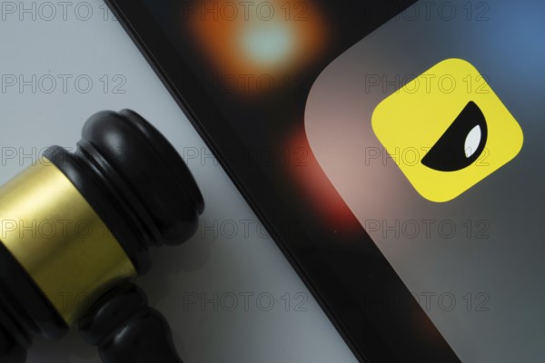 Dhaka, Bangladesh- 16 March 2025: A close up of an iPad screen displaying the Yubo app alongside a judge's gavel