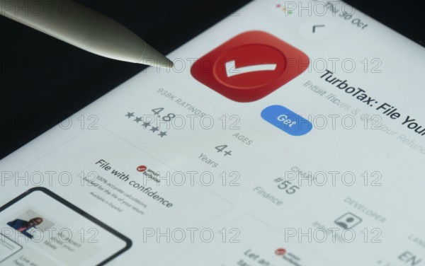 Dhaka, Bangladesh- 30 Oct 2025: TurboTax app on a iPad screen with a pen pointing at the install option