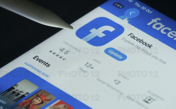 Dhaka, Bangladesh- 30 Oct 2025: Facebook app on a iPad screen with a pen pointing at the install option