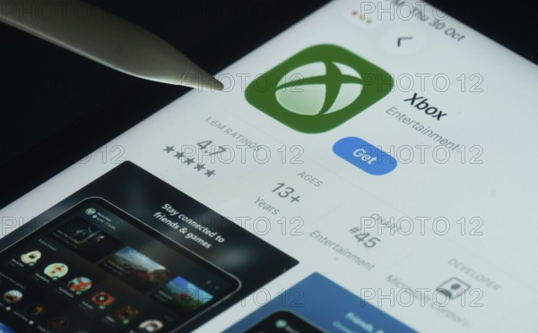 Dhaka, Bangladesh- 30 Oct 2025: Xbox app on a iPad screen with a pen pointing at the install option