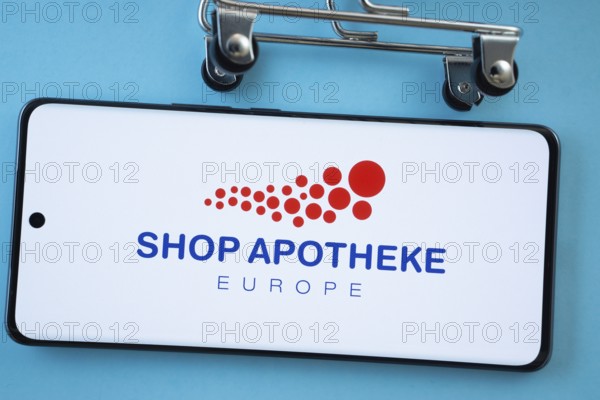 Dhaka, Bangladesh- 03 July 2025: Smartphone screen showing the (...) logo with shopping cart wheels on a blue background