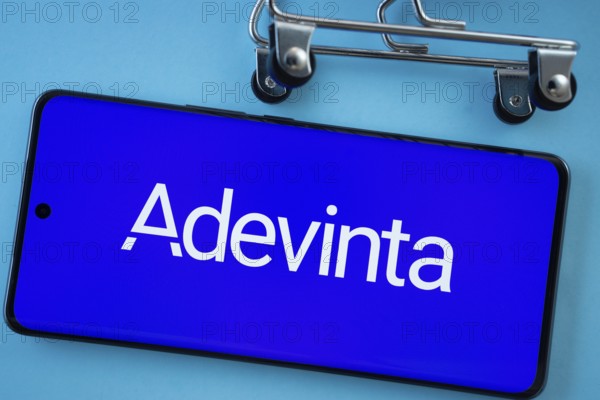 Dhaka, Bangladesh- 03 July 2025: Smartphone screen showing the Adevinta logo with shopping cart wheels on a blue background
