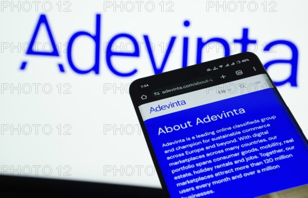 Dhaka, Bangladesh- 03 July 2025: Smartphone displaying Adevinta web interface against Adevinta logo background