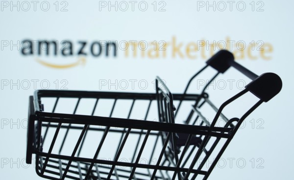 Dhaka, Bangladesh- 21 Nov 2025: Silhouette of a shopping cart in front of the amazon marketplace logo, symbolizing ecommerce and online shopping