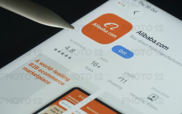 Dhaka, Bangladesh- 21 Nov 2025: Alibaba.com app on a iPad screen with a pen pointing at the install option