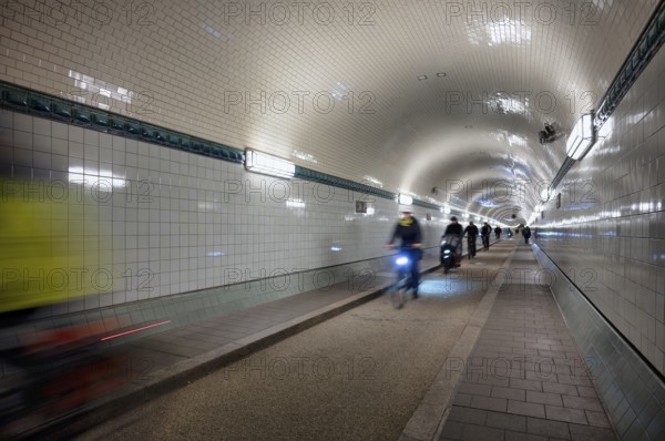 Interior view, pedestrians and cyclists crossing tunnel, mopping effect, movement, tube, historic old Elbe Tunnel, Free and Hanseatic City of Hamburg, Germany