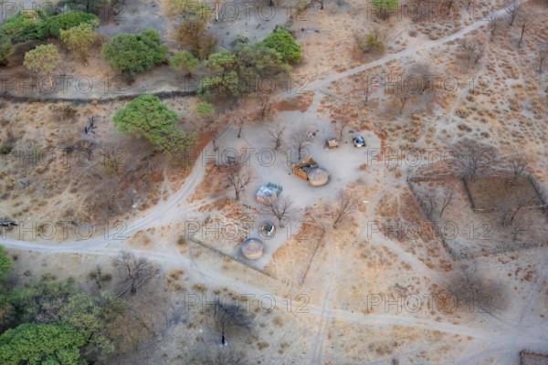 Settlement, simple house and fence, dry savanna landscape, near Maun, aerial view, Okavango Delta, Botswana