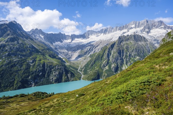Turquoise blue mountain lake Göscheneralpsee, picturesque mountain landscape with dammastock and damma glacier, Göscheneralp, Canton of Uri, Switzerland