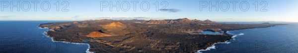 Coast with lava fields, volcanic landscape near Los Hervideros with red volcano Montaña Bermeja, in the evening light, aerial view, Lanzarote, Canary Islands, Spain