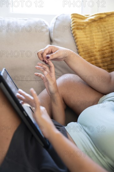 A happy lesbian couple shares a playful moment, showcasing a warm, intimate connection
