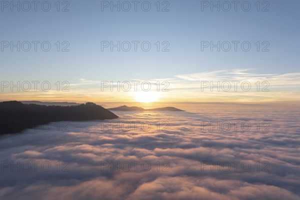 Sunset over the sea of fog from Beurener Fels to Hohenneuffen Castle, Swabian Alb, Baden-Württemberg, Germany