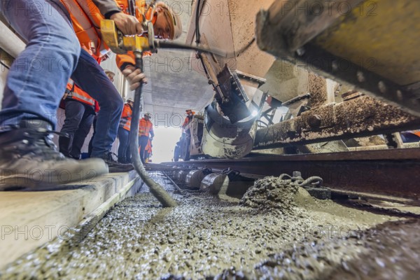 Deutsche Bahn AG track construction at Stuttgart Airport. The last few meters of solid road in the airport tunnel are concreted. This means that all long-distance railway tracks of Project S21 have been laid. Workers lay the rails and concrete the track bed. Stuttgart, Baden-Württemberg, Germany