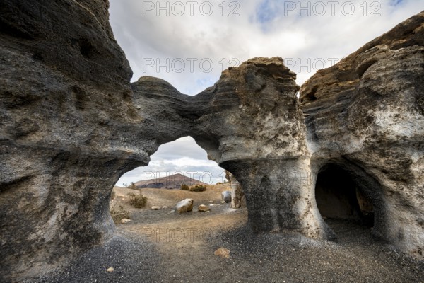 Eroded rock formations, volcanic landscape with dramatic cloudy skies, Ciudad Estratificada or Los Roferos, Antigua Rofera de Teseguite, Lanzarote, Canary Islands, Spain