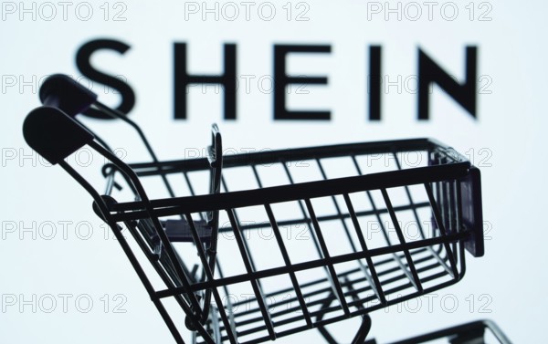 Dhaka, Bangladesh- 03 July 2025: Silhouette of a shopping cart in front of the SHEIN logo, symbolizing ecommerce and online shopping