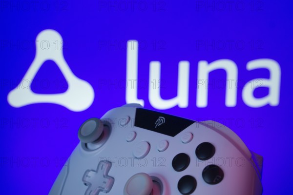 Dhaka, Bangladesh- 14 Nov 2025: A close-up of a gamepad with the Amazon Luna seen on screen in the background