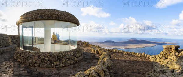 Stairway and viewing platform at the Mirador del Río viewpoint, in the evening light with sun stars, designed by artist César Manrique, view of the island of La Graciosa, Lanzarote, Canary Islands, Spain