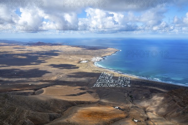 View from the Risco de Famara cliffs to the coast and the sea with the Famara beach, Playa de Famara, Lanzarote, Canary Islands, Spain