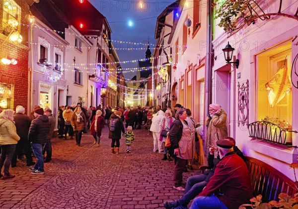 People in the Tiefstraße decorated for the Martin train in the evening, historic old town, Kempen, Lower Rhine, North Rhine-Westphalia, Germany