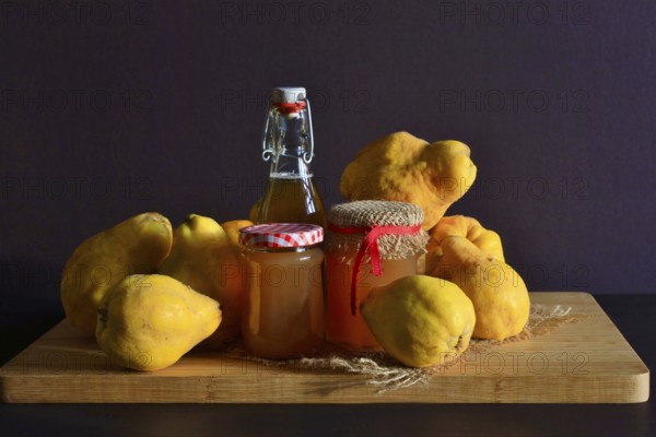Still life with quinces, homemade quince jelly and quince liqueur, autumn, Germany